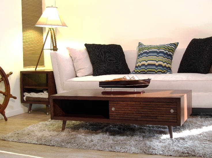A rich stained mid century modern coffee table with a little drawer and an open storage compartment, on tapered legs is amazing and timeless