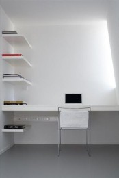 a minimalist white home office with a skylight, a built-in desk and matching shelves plus a white chair is a cool space to work
