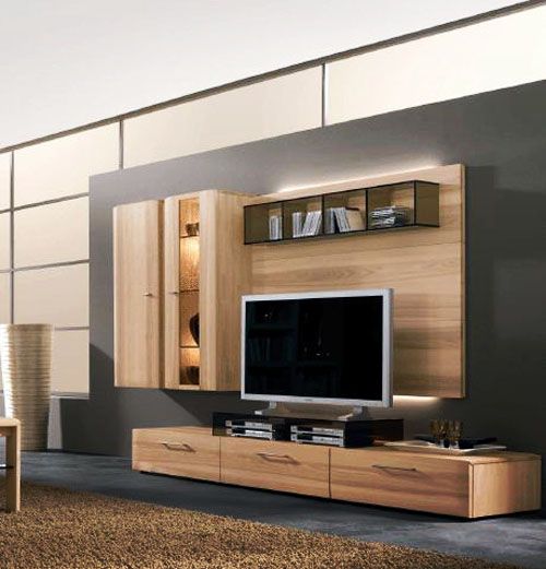 A modern light stained plywood TV unit plus a wall mounted part with lights and a cabinet attached on one side