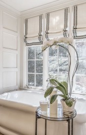 striped Roman shades perfectly fit a beautiful and elegant bathroom match the style and the look of the space