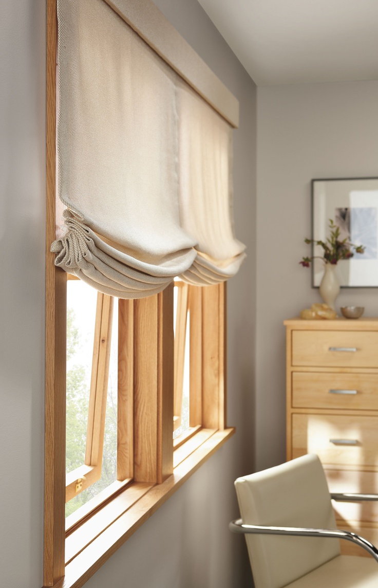A neutral Roman shade will add a cozy feel to the room and will block out the sun being private at the same time
