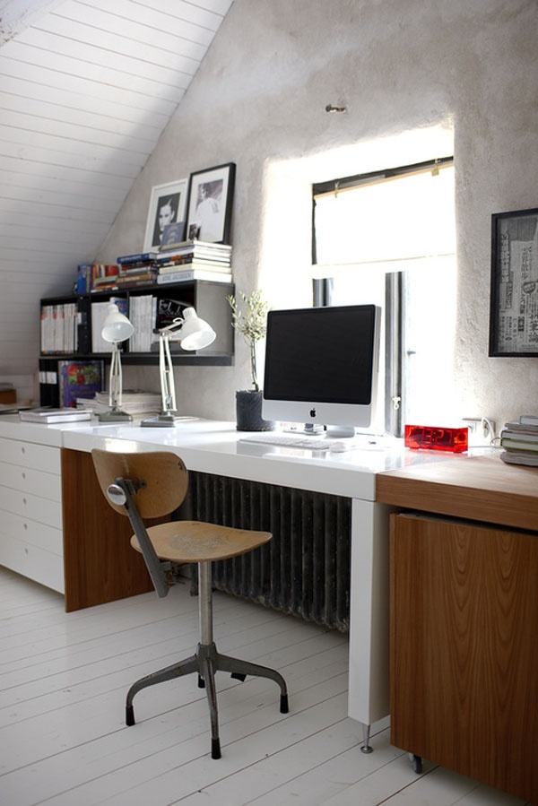 A Scandinavian home office in white, with a large storage desk, a plywood and metal chair, a stained storage unit, wall mounted shelves
