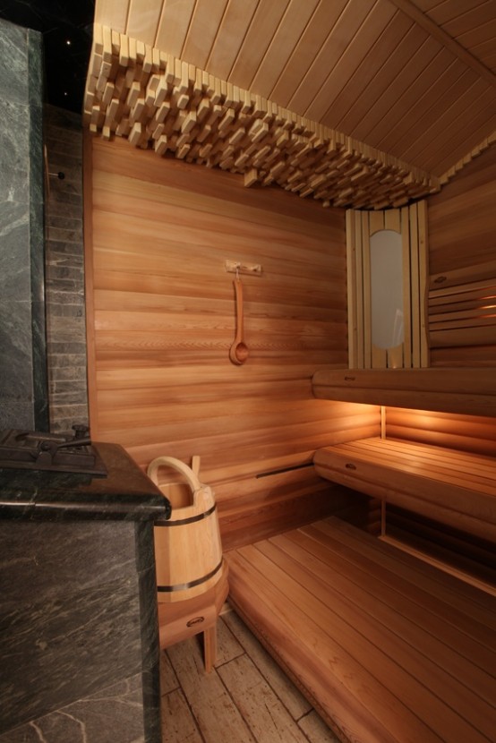 a lovely wood clad steam room with benches at various levels, bricks on top and built-in lights