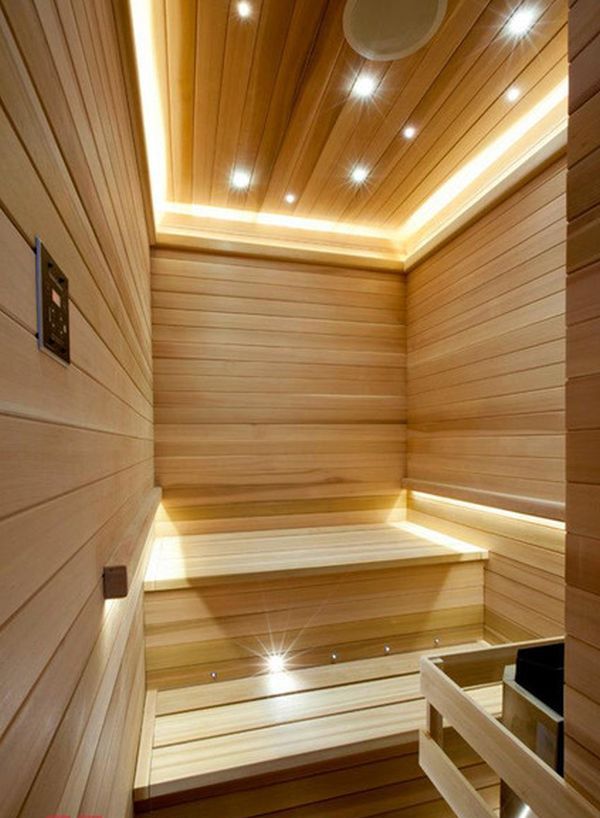 A modern steam room clad with wood, with lots of built in lights to make the space more welcoming