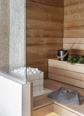 a tiny steam room clad with wood and just a couple of step benches is very welcoming and warming up
