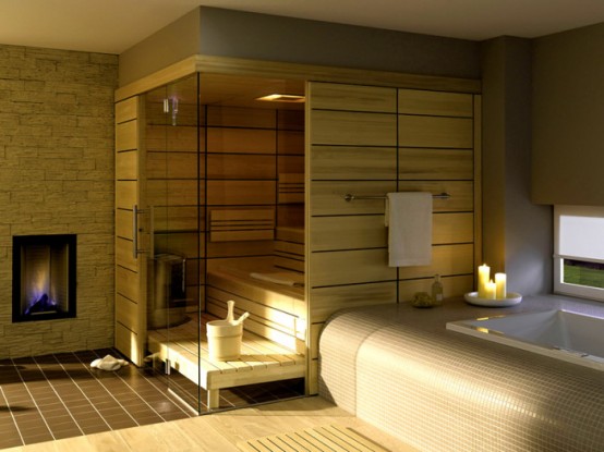 a tiny steam room clad with light-colored wood, with step benches and some built-in lights and a hearth is amazing