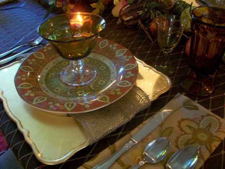 A square yellow plate and an orange and green patterned one for a colorful and bright rustic Thanksgiving tablescape