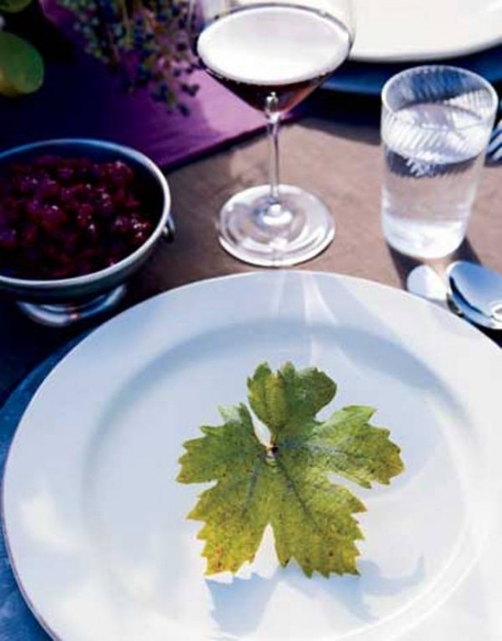 a lovely white round plate accented with a single fall leaf for a very modern and fresh Thanksgiving tablescape