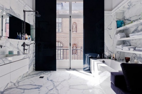 Marble is a great materials to design a luxurious bathroom. Mixed with dark accents you can make such bathroom more manly.