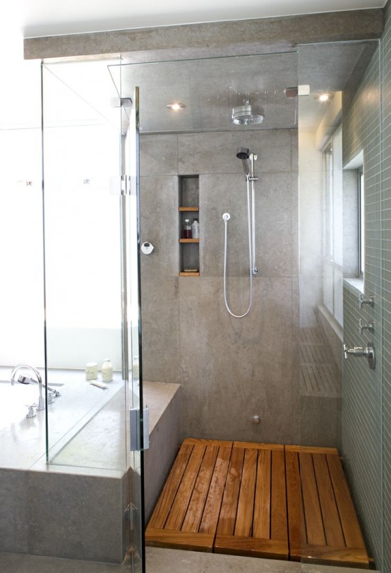 a concrete shower space with a wooden floor, a concrete floor in the bathroom for a contemporary feel