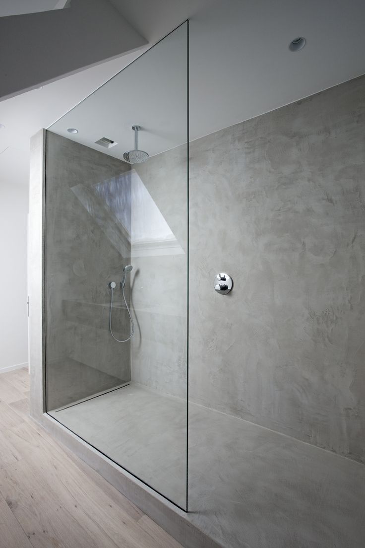An ultra minimalist concrete bathroom with a shower space clad with glass is a very elegant and chic space to be
