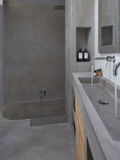 a minimalist concrete bathroom with a built-in tub and a vanity with a double sink in one is rather wabi-sabi