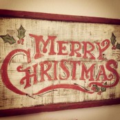 a vintage Christmas sign of a whitewashed wooden plaque and red letters plus a red frame is a stylish vintage rustic decor idea for the holidays