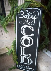 a black chalkboard Christmas sign is a nice idea for outdoors and indoors and you can change what’s chalked from time to time