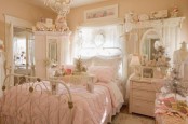 a neutral shabby chic bedroom with buttermilk walls, white and pastel furniture, blush bedding and refined detailing