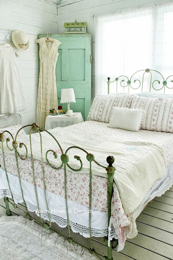 A neutral vintage bedroom with elegant and refined furniture, a mint vintage door in the corner, neutral linens
