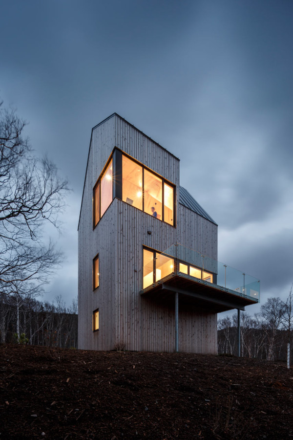 The cabin resembles a wooden tower ruling the location