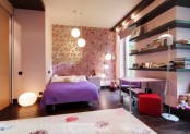 a bright teen bedroom with a printed wall, dark wall shelves, a lilac bed and a bright red ottoman and a printed rug