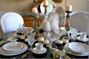 white porcelain, white pumpkins, candles and a large turkey paired with a dark table give a bold and contrasting look to the table