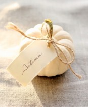 a white pumpkin and a white card are nice for decorating your space for Thanksgiving