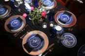 blue and white porcelain and bold blue glasses paired with metallic touches and bold blooms make up a bold Thanksgiving tablescape