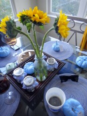 light blue pumpkins and blue textile placemats can be used to spruce up your modern Thanksgiving tablescape