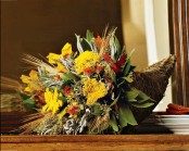 a cornucopia filled with bright blooms, foliage and wheat is a perfect Thanksgiving centerpiece to rock
