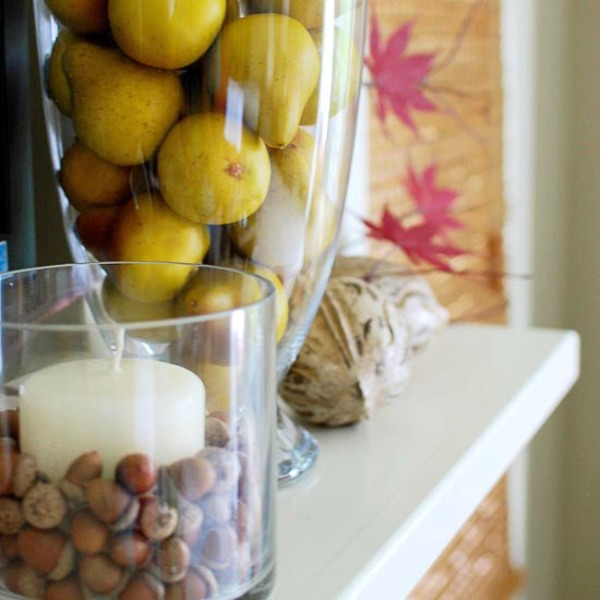 Glasses with acorns and pears, twine balls and fall leaves will help you to create a lovely and all natural Thanksgiving mantel