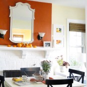 a very simple and cozy Thanksgiving mantel with natural orange pumpkins and nothing else is ideal for a modern or mid-century modern space