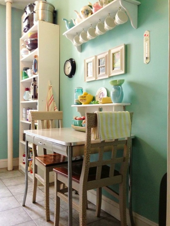 a small vintage dining zone with a neutral table and chairs, an open shelf and a gallery wall plus colorful accessories