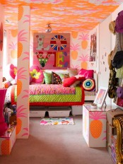 a super colorful and whimsical girl’s room with a bold orange ceiling, a bold printed artwork, a bed with colorful printed bedding and curtains