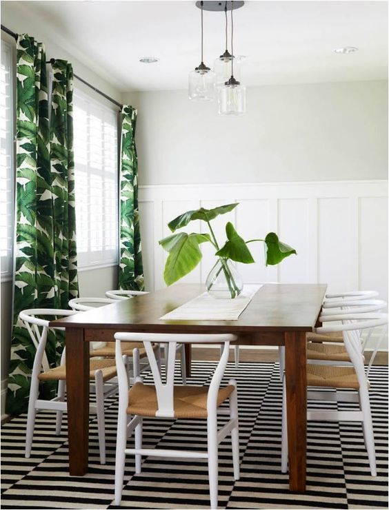 tropical-inspired dining area with Stockholm rug