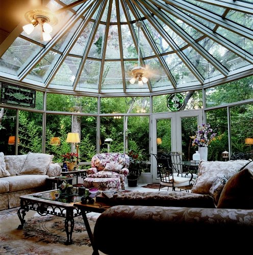 Gorgeous gazebo-shaped sunroom with vintage furniture.