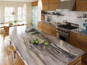 grey stone countertops with sandy wooden cabinets create a modern meets rustic kitchen look