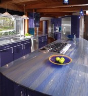 purple cabinets and striped purple and neutral stone countertops for a bright and colorful kitchen look