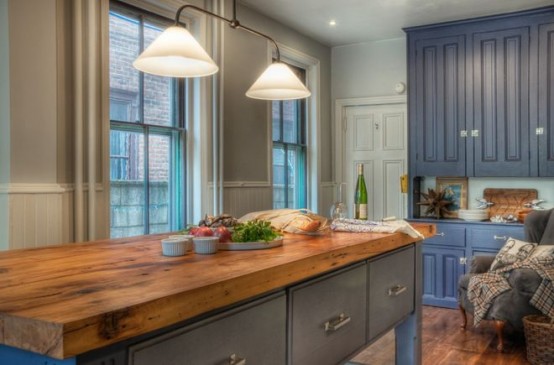 a vintage grey kitchen island with a butcherblock countertop for a contrast and a bold look