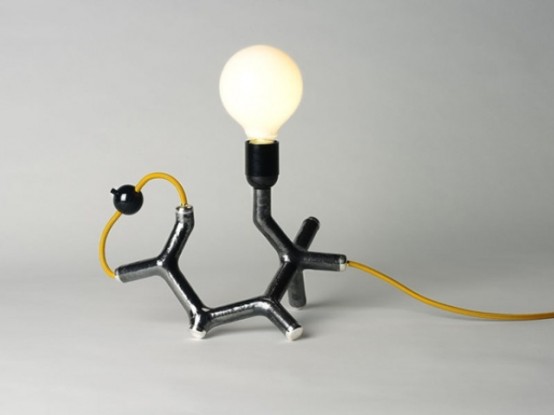 a fun chemistry-inspired table lamp in gold, black and with a bulb is a cool and catchy idea