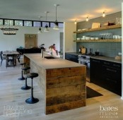 a rough pallet wood kitchen island with a concrete tabletop and a built-in sink is a cool contemporary meets rustic idea