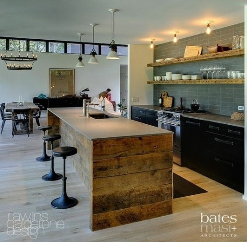 A rough pallet wood kitchen island with a concrete tabletop and a built in sink is a cool contemporary meets rustic idea