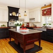 a redwood kitchen island on a platform with a metal countertop stands out in a black kitchen and features open storage space