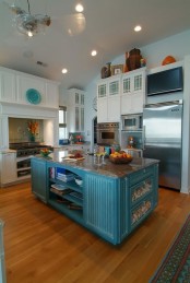 a bright blue vintage kitchen island with a stone countertop, open and closed storage compartments