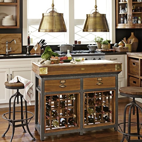 A small metal and wood kitchen island with drawers and wine racks inside is a very space effective piece