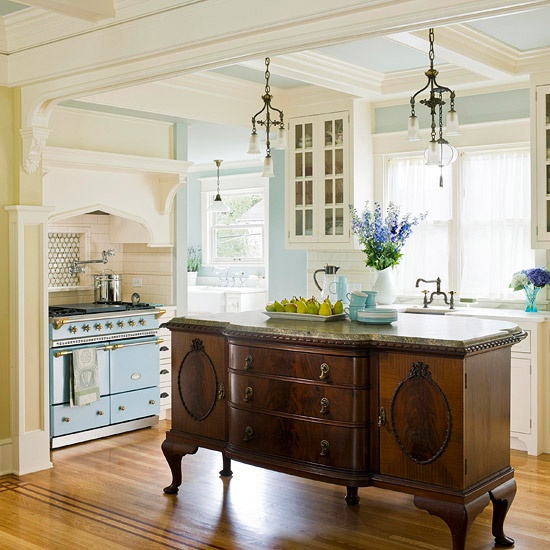 a rich-stained vintage dresser makes a statement and contrasts the neutral and pastel kitchen while matching the style