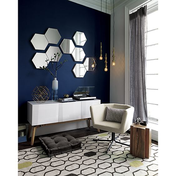 An arrangement of hexagon shaped mirrors on the wall will make it more eye catchy and cool and will bring a cool and edgy touch to the room