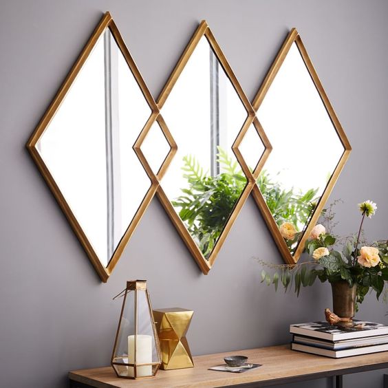 A rhomb shaped triple mirror in brass frames is a lovely idea for a modern space, it brings a touch of geometry and shine to the space