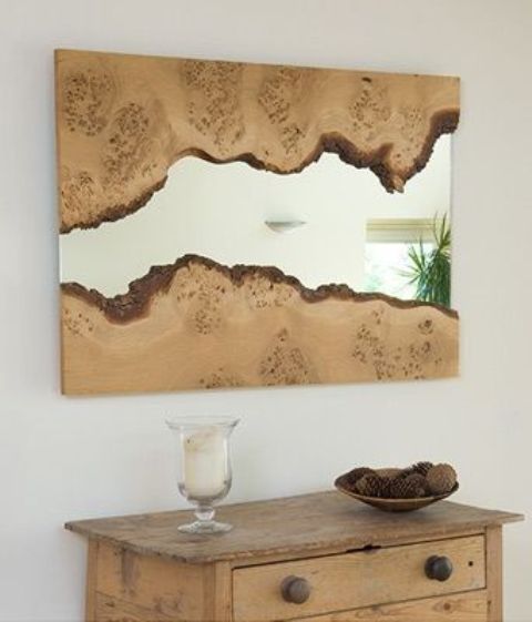 a beautiful nature-inspired mirror clad with wood with a living edge and mirror in the center is a beautiful solution for an organic and nature-inspired space