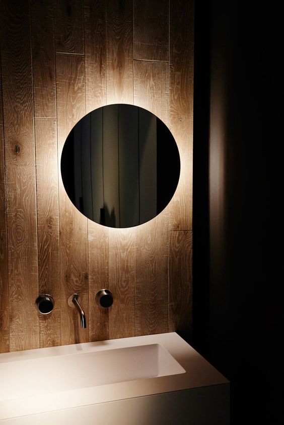 a simple round mirror that is lit up will allow you not to turn on light in the bathroom and will add a moody feel to the space
