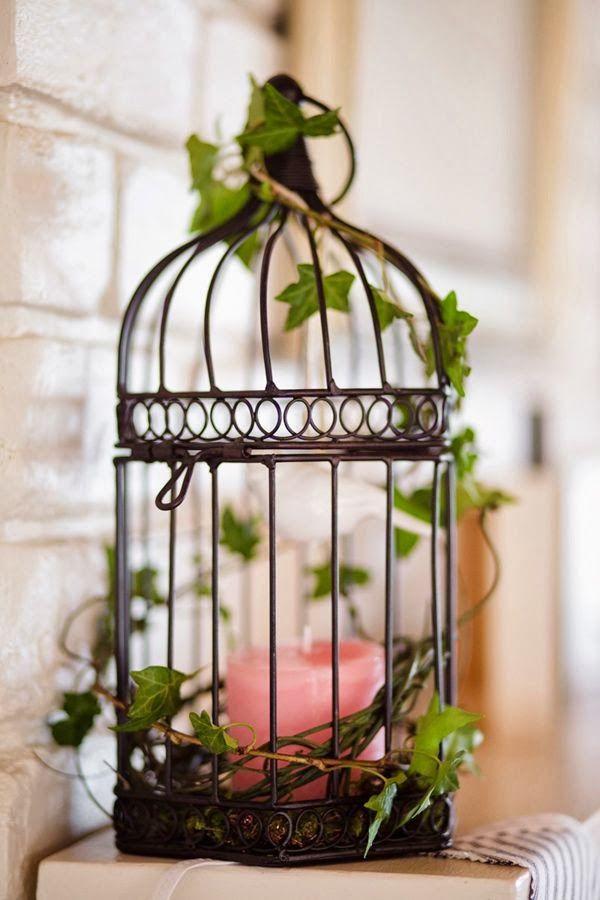 A little bird cage is an interesting alternative to a candle lantern.