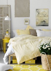 a bright and chic bedroom with a white IKEA Ranarp lamp and rough artworks and shutters that add a rough touch to the space