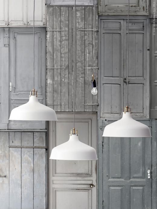 a cluster of white Ranarp pendant lamps can be used in any space, whether it's an entryway or a kitchen